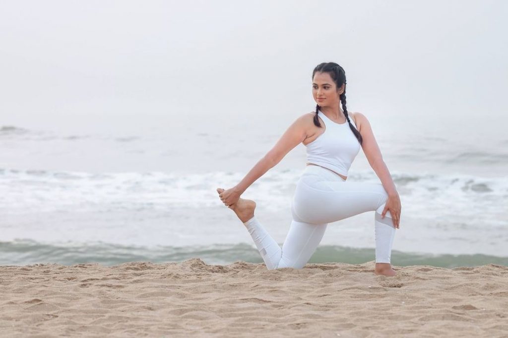 fitness mixed race asian woman in yoga pose on the morning beach, beautiful  fit woman practice fitness exrxise stones, morning sea or ocean background  7567182 Stock Photo at Vecteezy